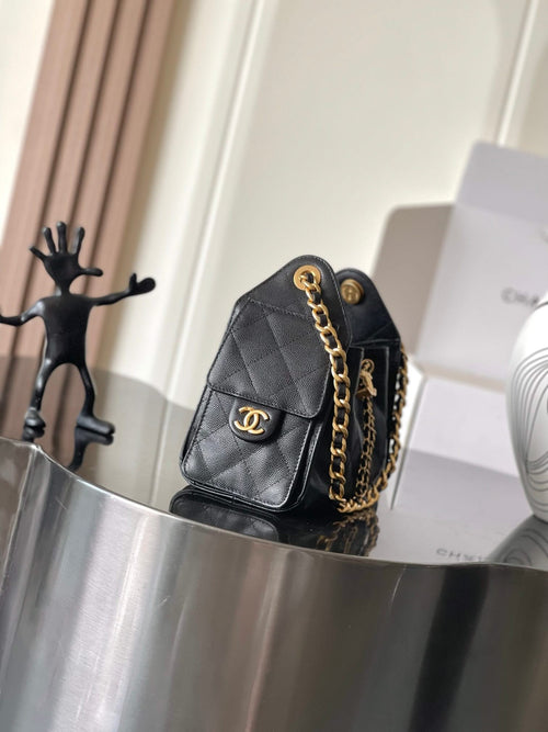 Black Chanel quilted flap bag with CC logo, gold chain strap, and turn-lock