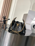 Black Chanel quilted shoulder bag with gold chain strap and front flap hardware