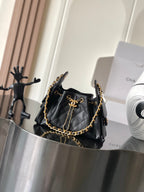 Black Chanel quilted shoulder bag with gold chain strap and front flap hardware