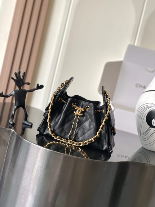 Black Chanel quilted shoulder bag with gold chain strap and front flap hardware
