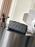 Black Chanel quilted flap bag with gold chain shoulder strap