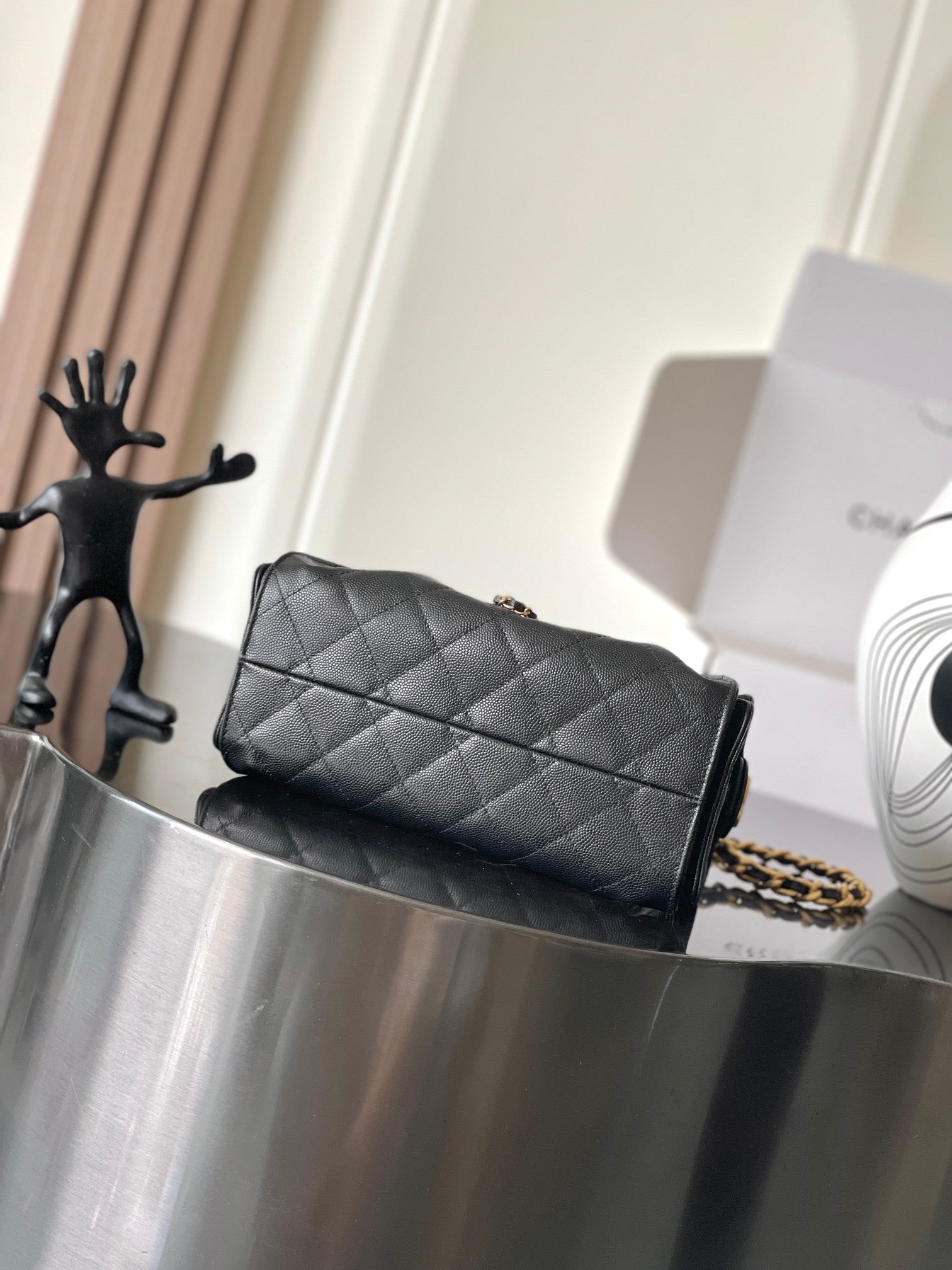 Black Chanel quilted flap bag with gold chain shoulder strap