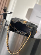 Black Chanel shoulder bag with open top and gold chain strap