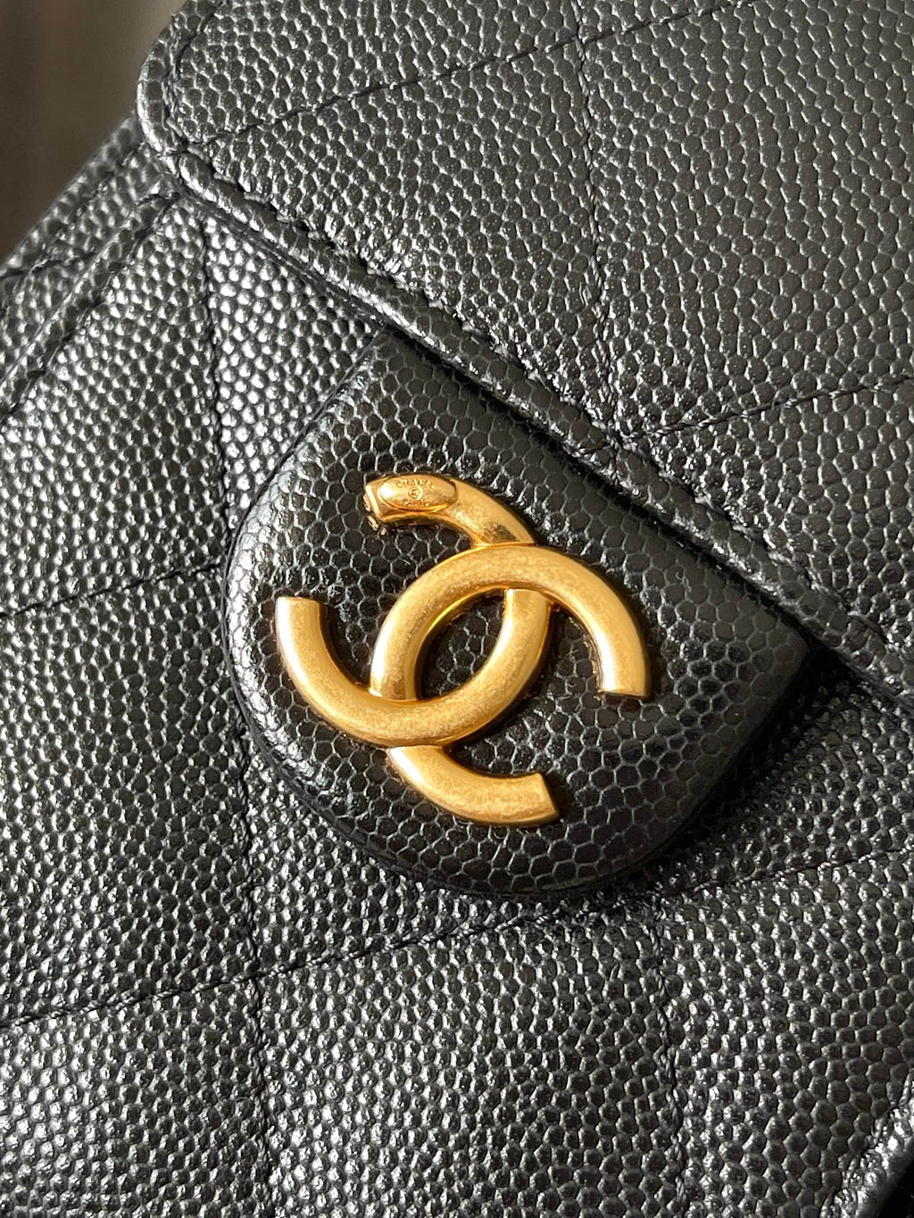 Black Chanel quilted leather flap with gold CC logo detail