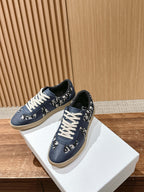 Navy blue low-top sneakers with white laces, patterned heel and side panels