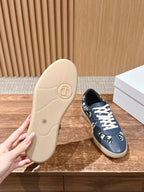Low-top sneaker outsole with navy blue upper and white laces