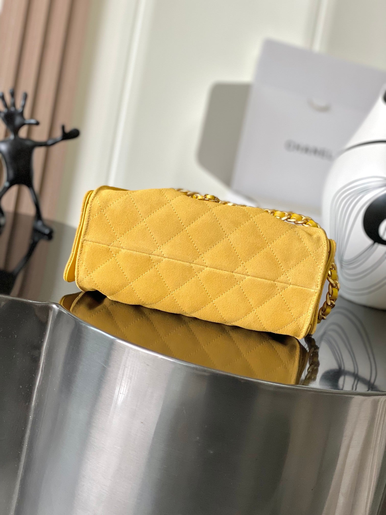 Chanel quilted clutch-style bag in yellow with gold chain strap and front flap