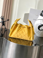 Chanel quilted shoulder bag in yellow with chain strap, top flap open