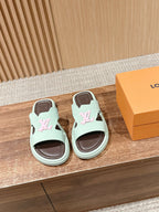 Mint green Louis Vuitton slide sandals with pink logo and dark brown footbed