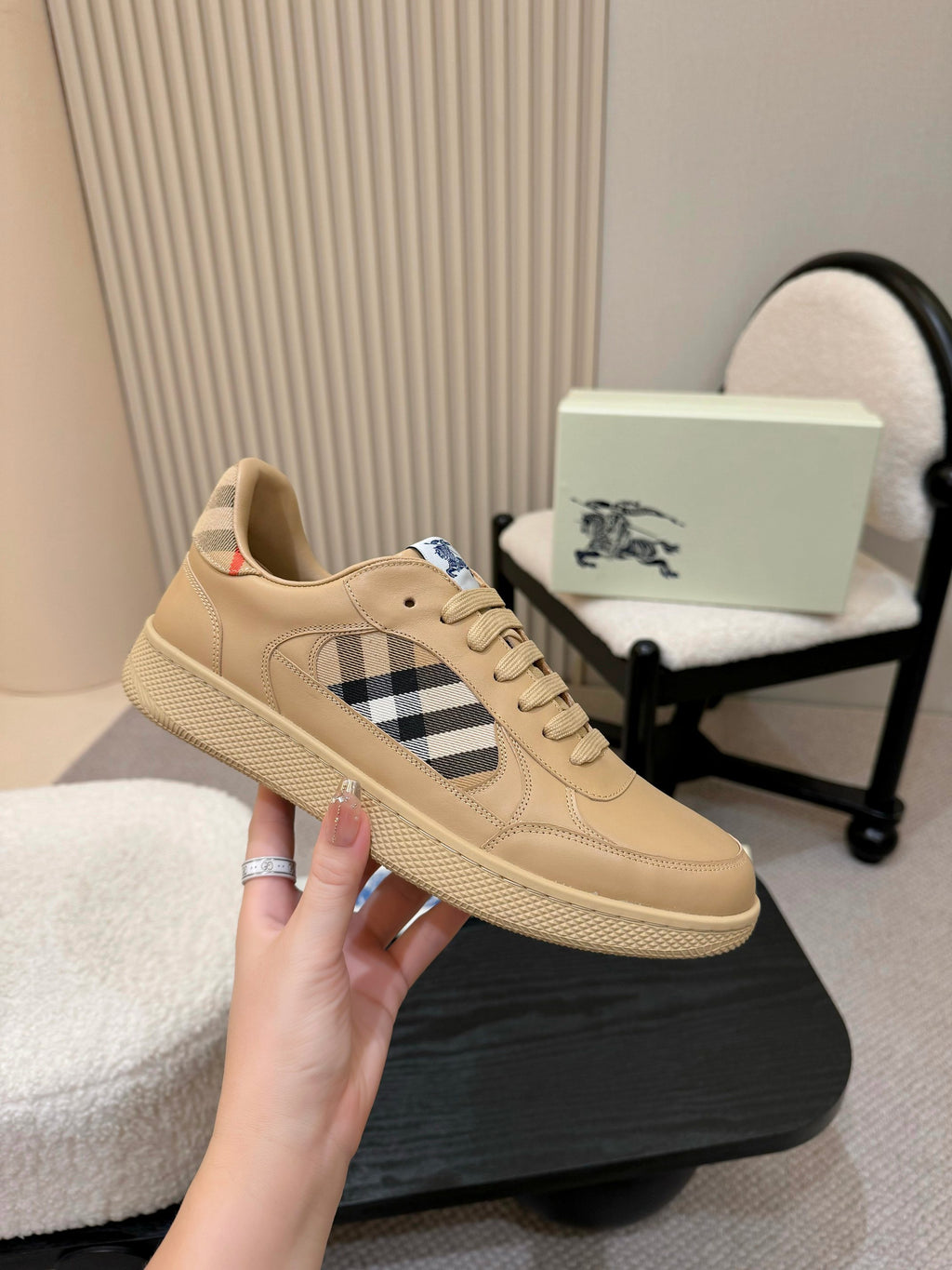Burberry beige sneaker on display, check side panel and lace-up front