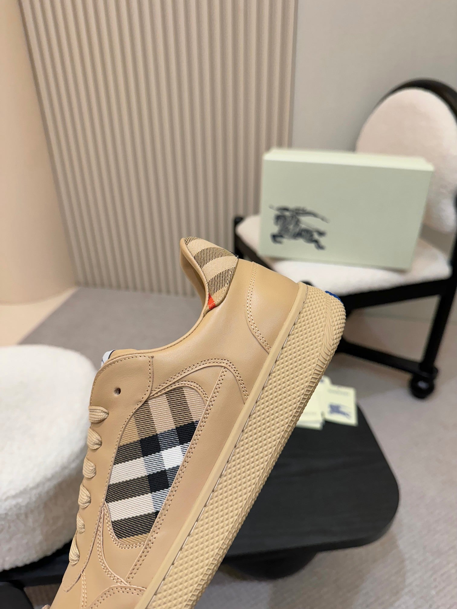 Burberry sneaker quarter view, beige with check insert and blue sole edge