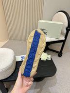 Burberry shoe outsole view, textured blue rubber tread on beige base