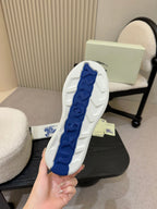 White sneaker outsole with blue traction pattern