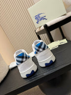 White sneakers with blue plaid heel panels, back view
