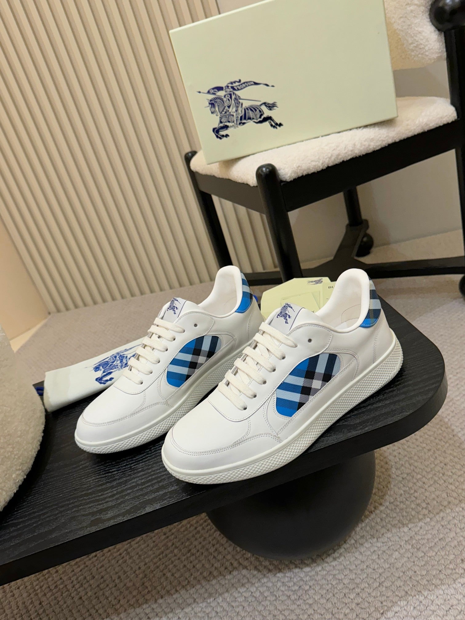 White lace-up sneakers with blue plaid overlays on the sides
