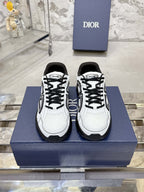 White Dior lace-up sneakers with black chunky soles, front view pair on box