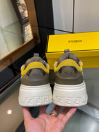 Fendi unisex sneakers rear view, white soles with yellow details and Fendi heel branding