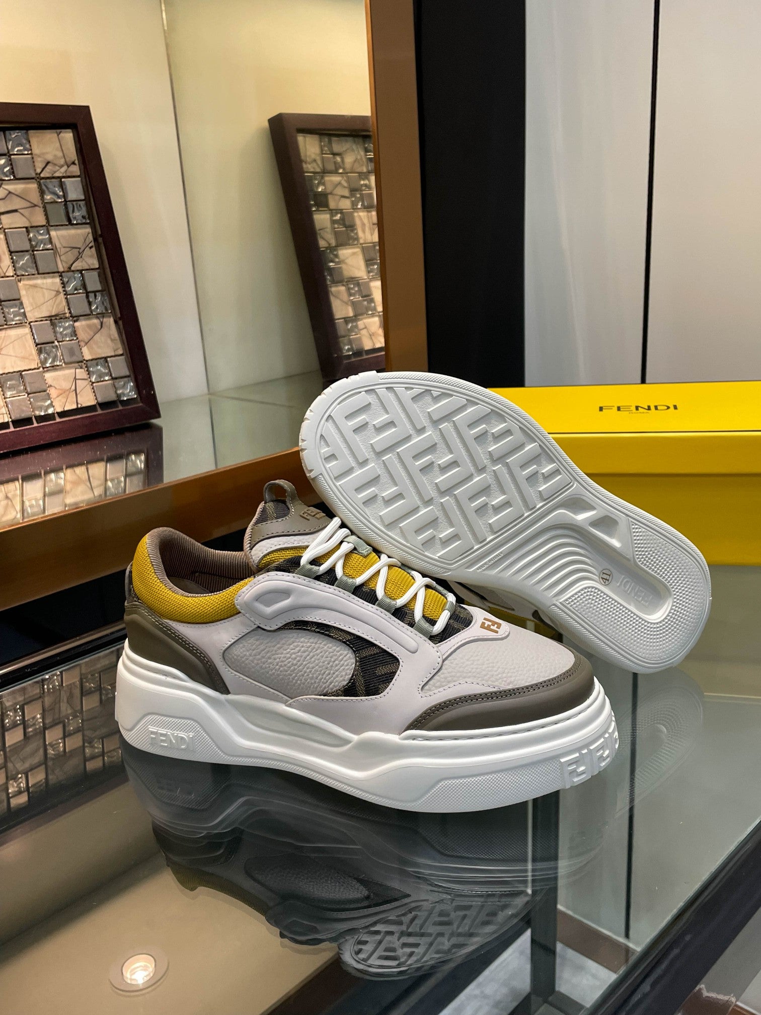 Fendi unisex sneakers with textured tread sole, gray and white uppers with yellow lace accents
