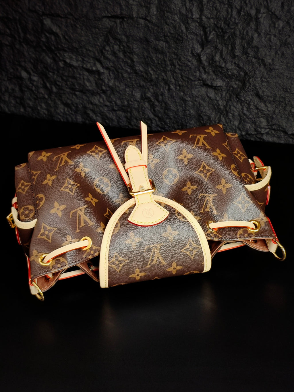 Louis Vuitton monogram canvas mini bag with white top handle and attached side straps