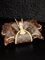 Louis Vuitton monogram canvas mini bag with white top handle and attached side straps