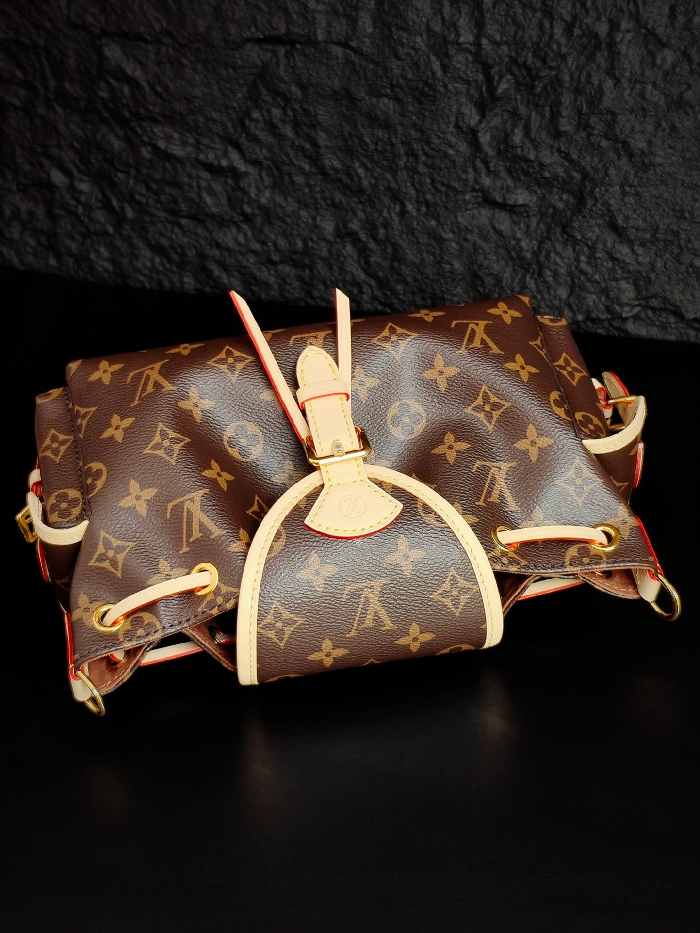 Louis Vuitton monogram canvas mini bag with white top handle and attached side straps