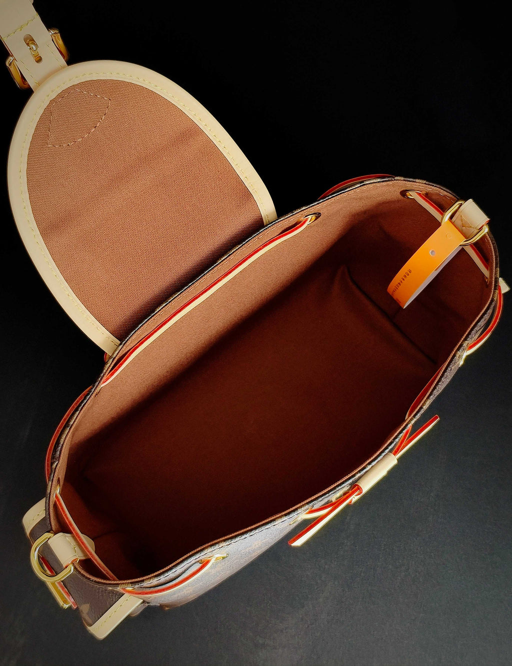 Louis Vuitton monogram canvas mini bag interior view with tan lining and front pocket