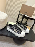 Burberry checkered lace-up sneakers with black and white plaid uppers, white rubber sole