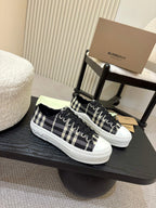 Burberry checkered lace-up sneakers with black and white plaid uppers, white rubber sole
