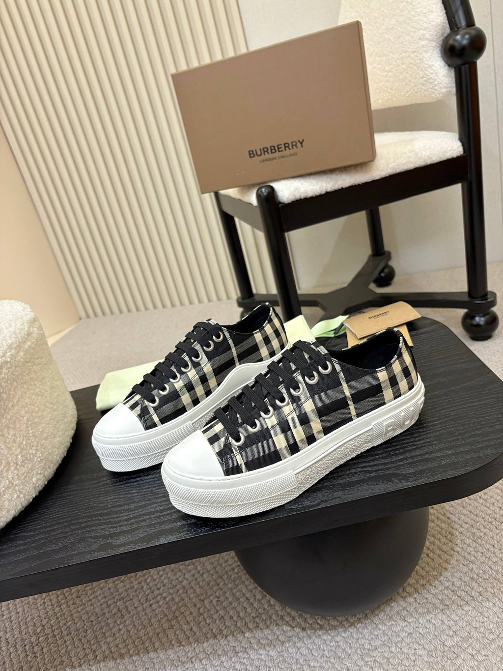 Burberry checkered lace-up sneakers on a stand, black-and-white plaid with white sole