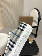 Burberry low-top sneaker side view, black and blue check upper with white sole