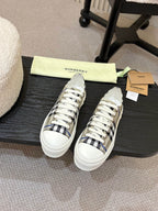 Burberry low-top sneakers pair, black and blue check uppers with white rubber sole