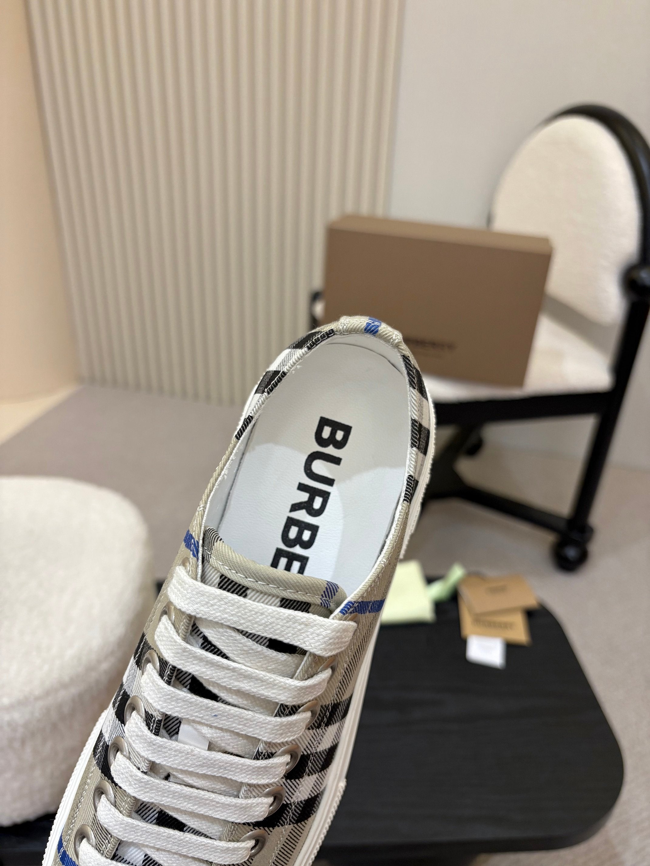 Burberry sneaker interior view, white upper with black-blue check collar