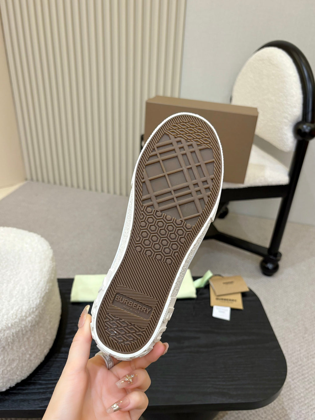 Burberry sneaker outsole tread, held in hand with textured rubber grip