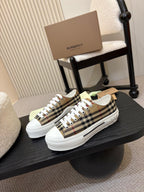 Burberry low-top sneakers with black plaid pattern and white rubber sole