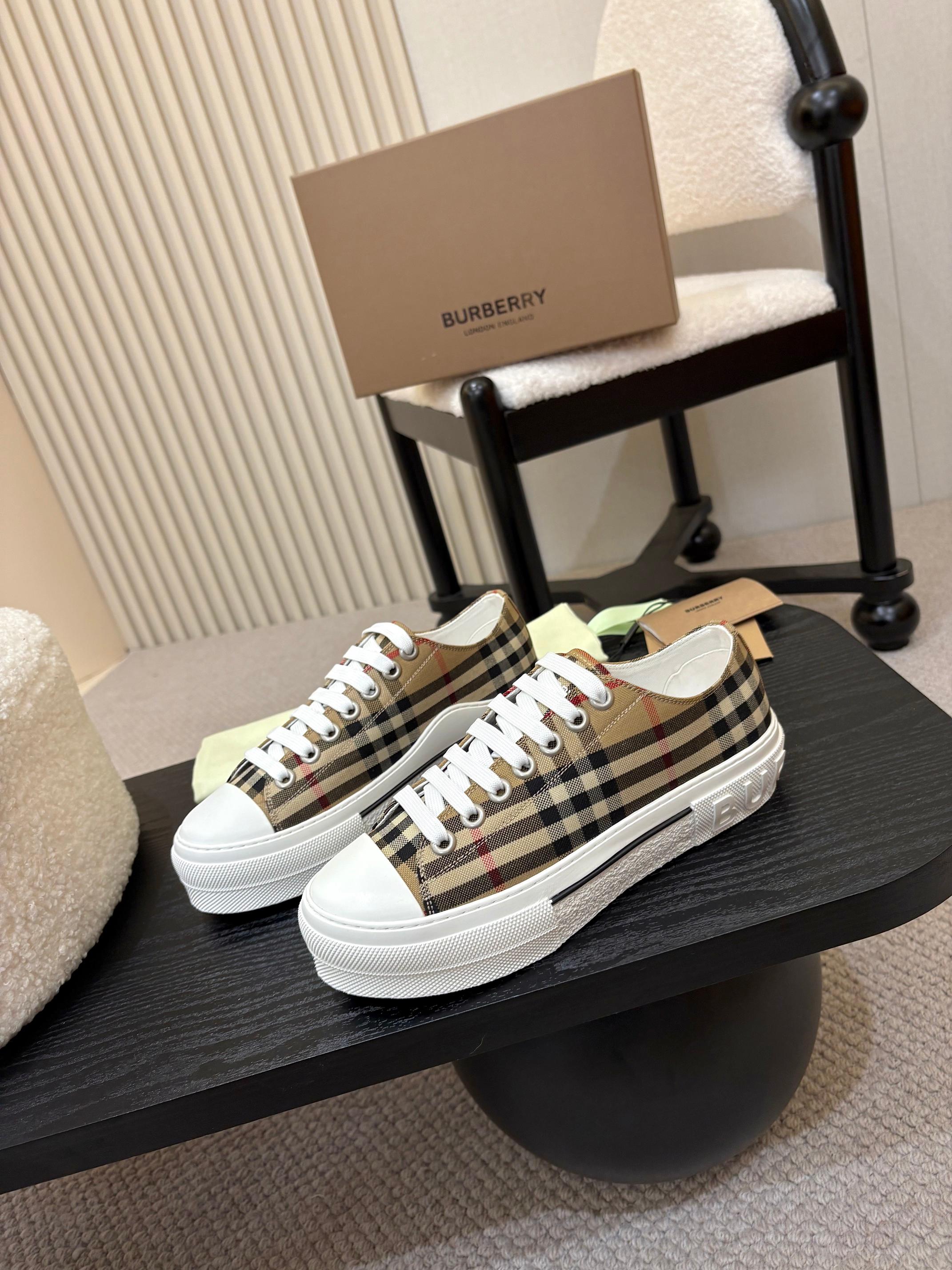 Burberry low-top sneakers with black plaid pattern and white rubber sole