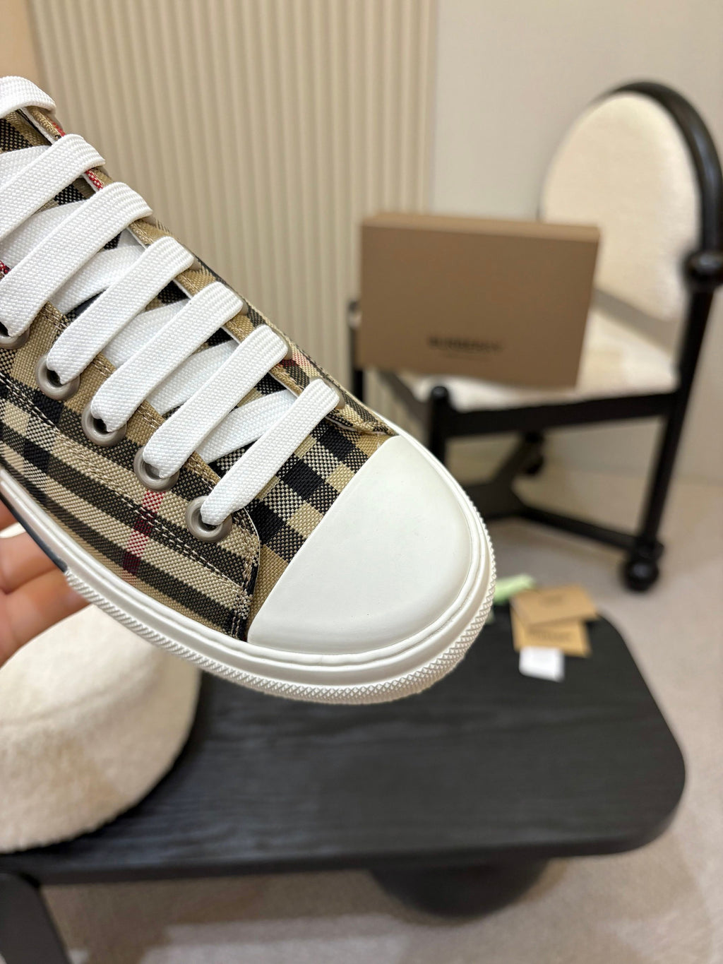 Burberry sneakers close-up: plaid side panel, white laces, and white toe cap