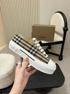 Burberry sneakers, side view with plaid fabric upper and white rubber sole