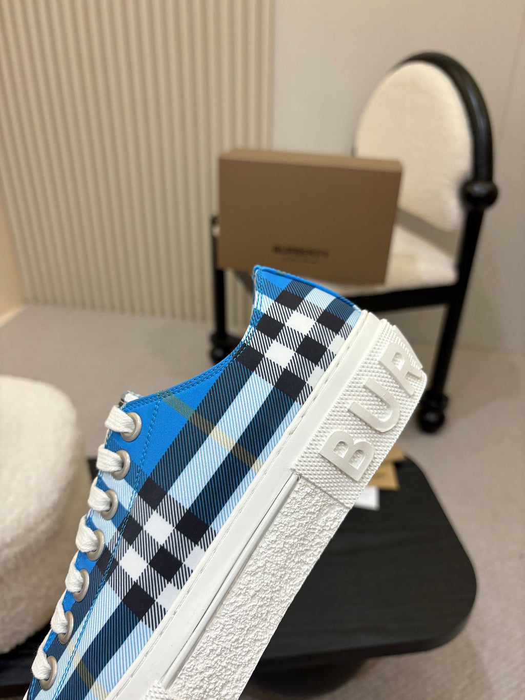 Burberry sneaker side view, blue plaid slip-on style with white outsole