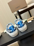 Burberry low-top sneakers on a display table, blue plaid uppers