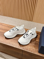 White Dior unisex sneakers, lace-up style, on display with box