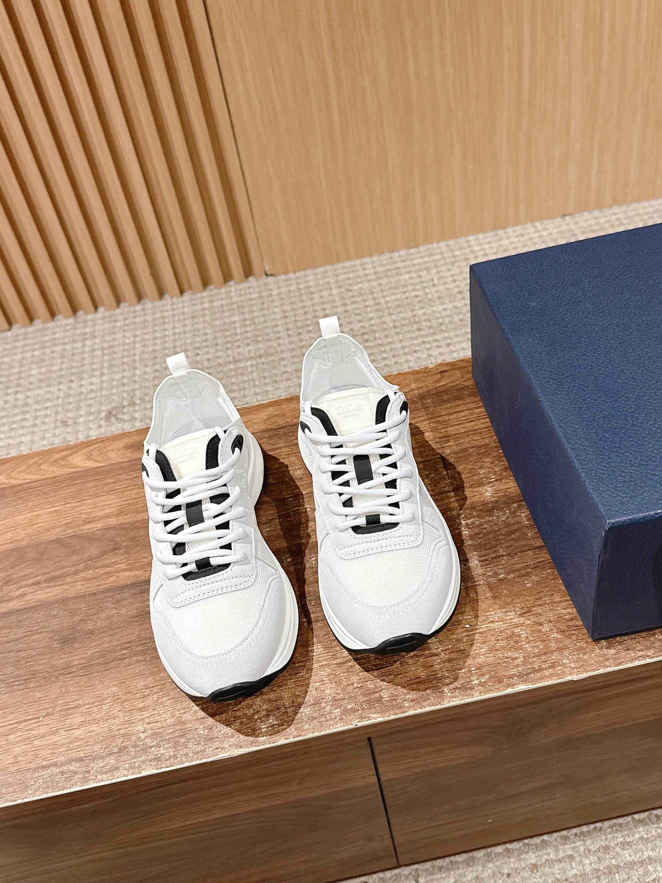 White Dior unisex sneakers with black logo detail and white laces