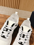White Dior lace-up sneakers, black tongue insert, shown with two shoes