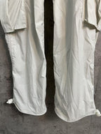White cargo pants with wide legs and side hem ties