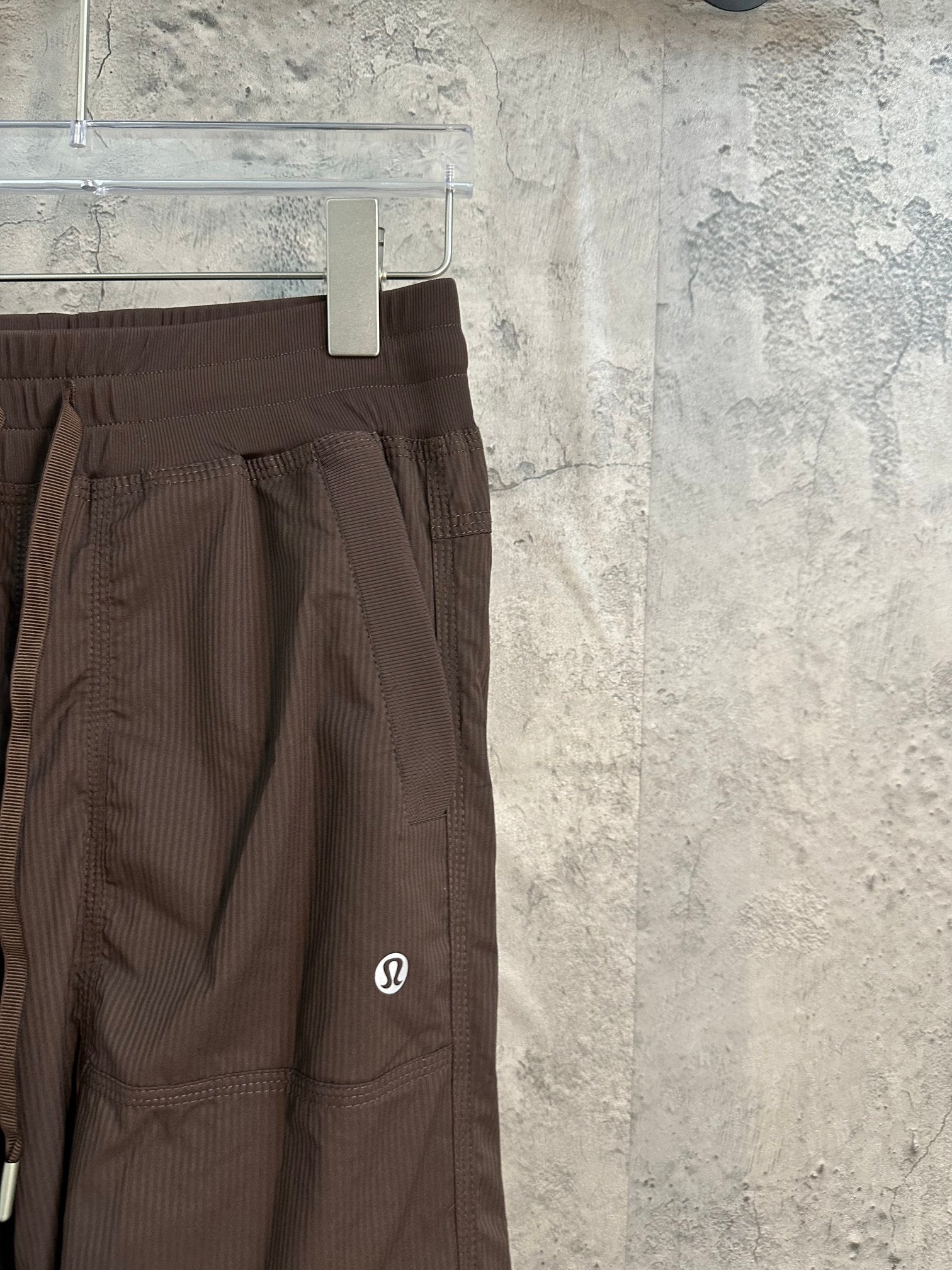 Brown cargo pants showing side pocket and stitched seams