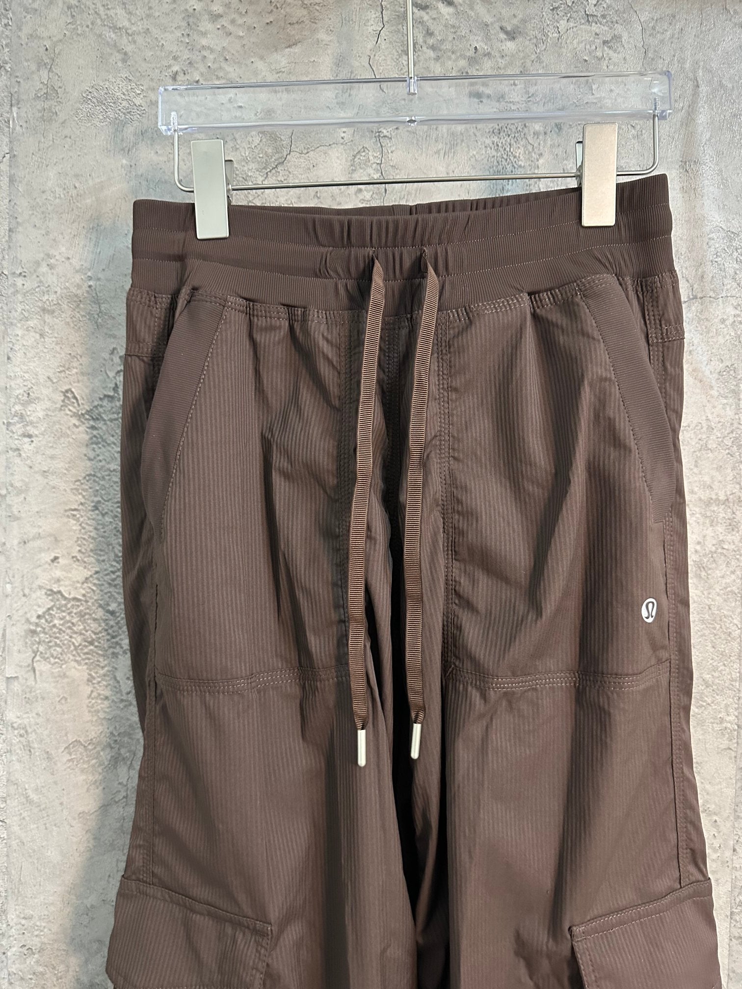 Brown cargo pants with flap side pockets and drawcord waist