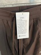 Lululemon hang tag attached to brown cargo pants waistband