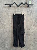Black cargo-style pants with drawstring waist and side pockets