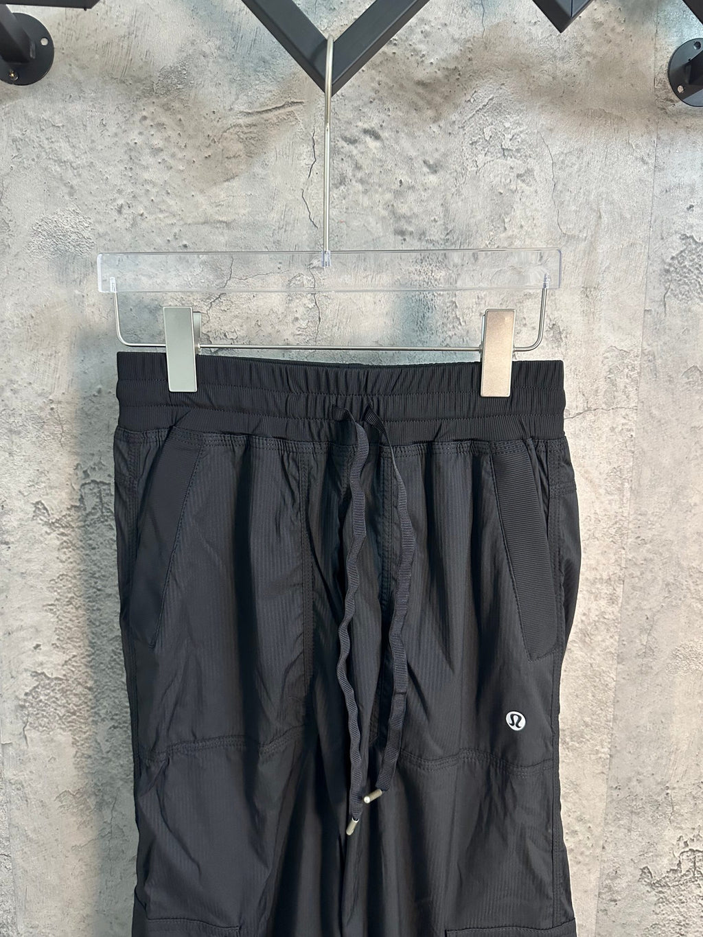 Black elastic-waist cargo pants with drawstring and side zip pocket