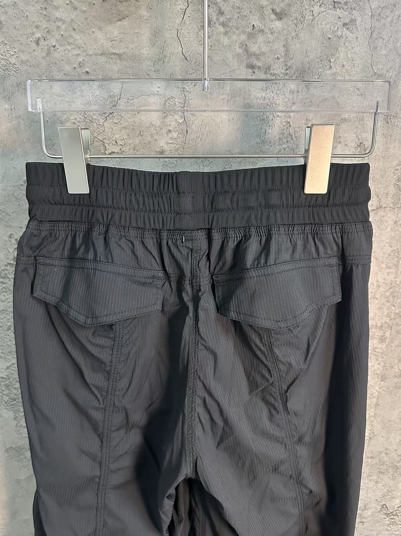 Black cargo pants with elastic waistband and drawstring fly