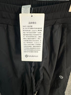 Black cargo pants with drawstring waist and Lululemon hang tag